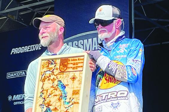 Rick Clunn (right) gets an engraved map from Scott Doolittle during Friday’s weigh-in ceremony. (MARK BLUMENTHAL / Palatka Daily News)