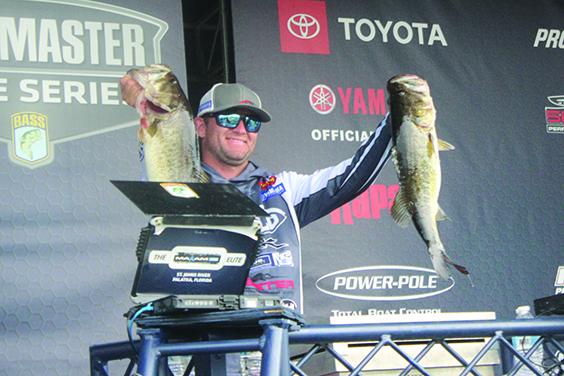 Tournament leader Cory Johnston of Cavan, Ontario, Canada, shows off some of his 27-pound, 8-ounce catches during Friday’s second day of the MAXAM Tire Bassmaster Elite at St. Johns River. (RITA FULLERTON / Special to the Daily News)