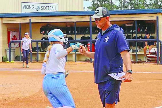 Caylee Elder, here congratulated by coach Joe Pound after hitting a home run against Pasco-Herando, hit three home runs in tournament play in Alabama in three games. (RITA FULLERTON / Special to the Daily News)
