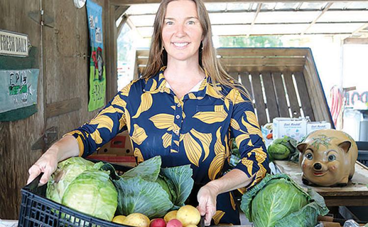 TRISHA MURPHY/Palatka Daily News – Jena Dennis pays a visit to the County Line stand near Hastings on Friday to check on the produce items that are the mainstay for the return of the Hastings Cabbage, Potato and Bacon Festival, which will take place next weekend. 
