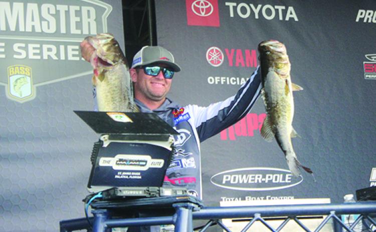 Tournament leader Cory Johnston of Cavan, Ontario, Canada, shows off some of his 27-pound, 8-ounce catches during Friday’s second day of the MAXAM Tire Bassmaster Elite at St. Johns River. (RITA FULLERTON / Special to the Daily News)