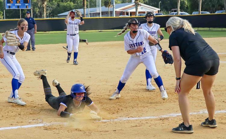 Palatka's Zoey Clark slides safely into third base after Keystone Heights botched a second-inning pickle play in Thursday's District 3-3A softball championship. (RITA FULLERTON / Special to the Daily News)