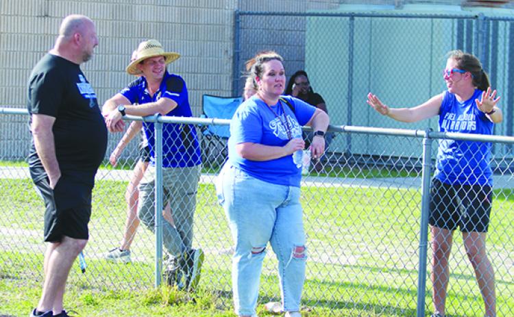 Interlachen track and field coach Gerald Swayze (far left) did not get back to Interlachen from the Region 2-2A championship in Mount Dora until 2 a.m. Wednesday morning, while Peniel Baptist Academy coach Talisa Fletcher (far right) didn’t get back to her house after 1 a.m. Wednesday from the same site in the Region 2-1A championship. (MARK BLUMENTHAL / Palatka Daily News)