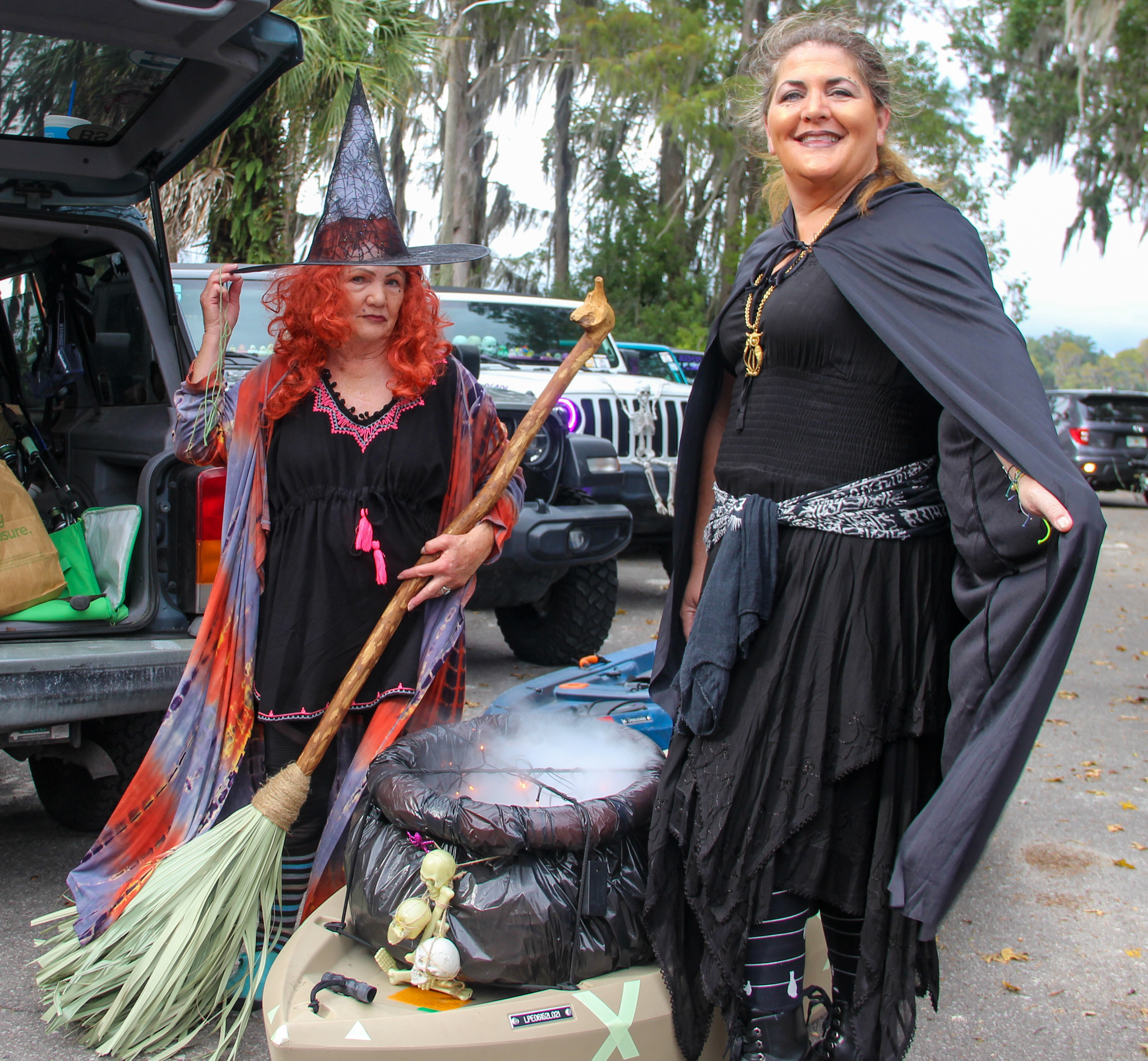 alatka woman Emma Shaw (left) stands next to St. Augustine woman Kiersten Hoey as they load up their cauldron with dry ice and prepare to kayak in the 2022 Melrose Bay Witches Paddle.