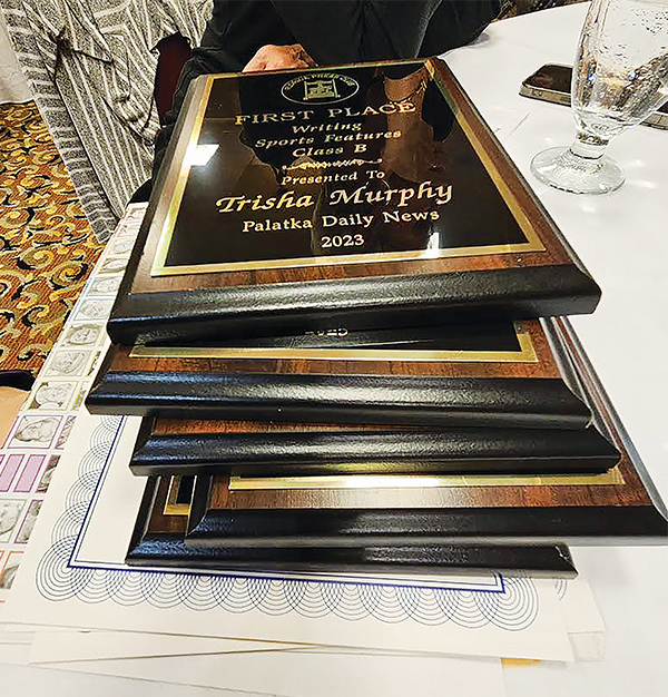 BRANDON D. OLIVER/Palatka Daily News – Pictured is a stack of Florida Press Club plaques and certificates, including the first-place prize Lifestyles Editor Trisha Murphy won for writing in the Sports Features category.