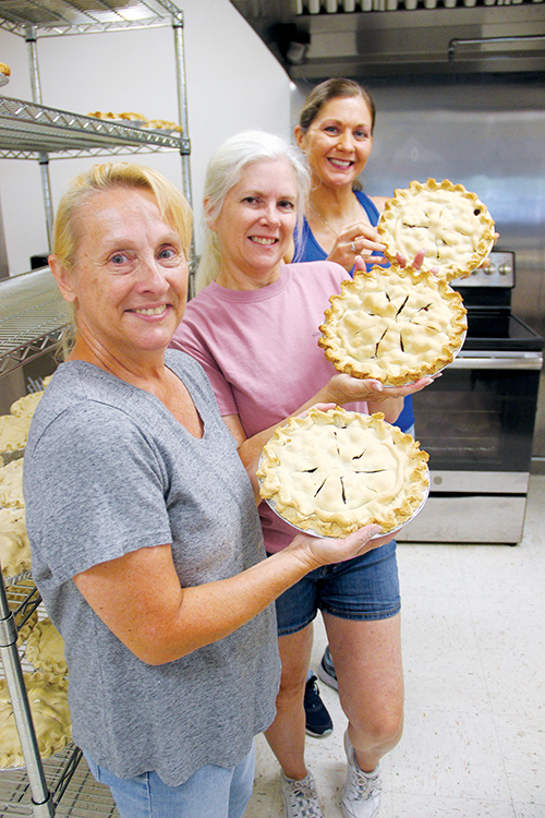 File photo – Bostwick Blueberry Festival volunteers hold some of the pies they made to sell at last year’s event.