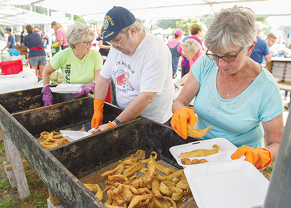 File photo – Volunteers assemble catfish plates to sell at a previous Catfish Festival in Crescent City.
