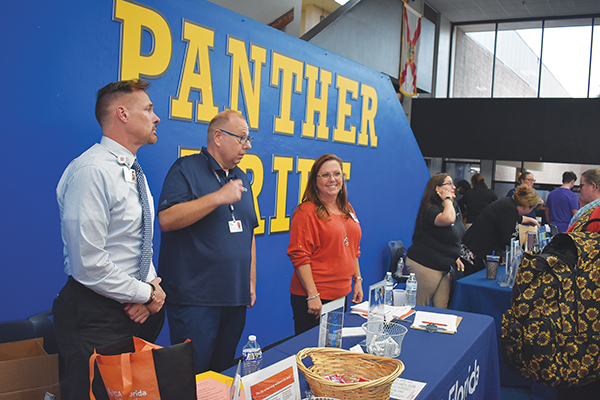 BRANDON D. OLIVER/Palatka Daily News – From left, HCA Florida Putnam Hospital CEO Brian Nunn, Manager of Communications and Community Engagement David Chudzik and Volunteer Coordinator Rose Bellamy are stationed at the hospital’s table during the College and Career Fair. 