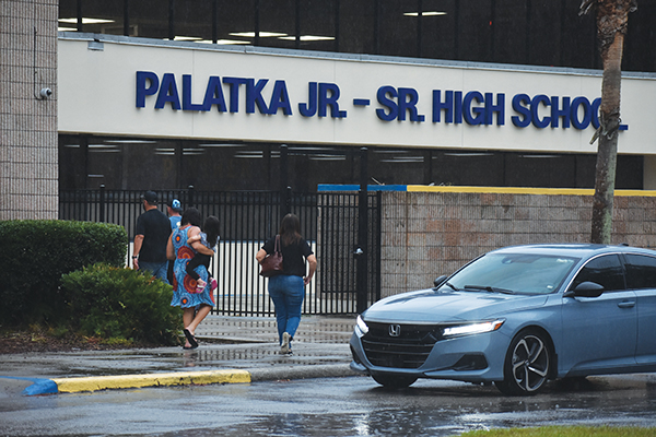 BRANDON D. OLIVER/Palatka Daily News – People slosh through the rain to attend the vigil for Baylee Holbrook at Palatka Junior-Senior High School on Wednesday.