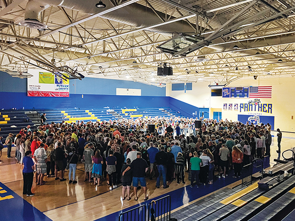SARAH CAVACINI/Palatka Daily News – Baylee Holbrook's loved ones gather in a circle inside the Palatka Junior-Senior High School gymnasium to pray for the teen.