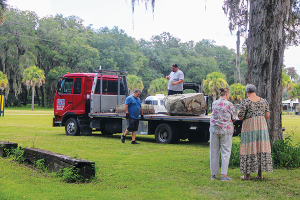 Submitted photo – Sisters Eileen Fulghum and Linda Sullivan stand to the side and watch as the Osceola Monument is unloaded at Palmetto Hall in Florahome in August.