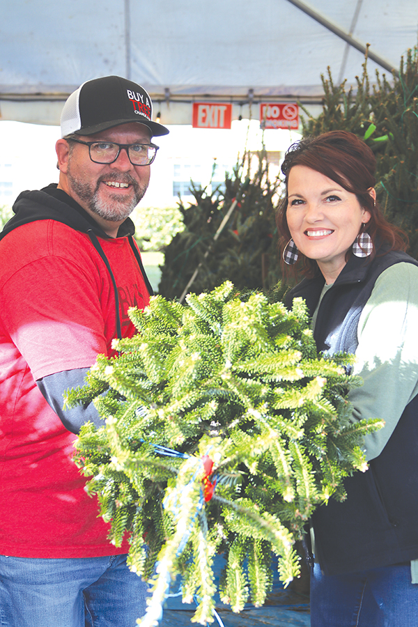 TRISHA MURPHY/Palatka Daily News – Steve Burkowske and his wife, Dawn, are ready to set up one of the Fraser fir Christmas trees that are part of Buy A Tree Change A Life – Palatka.