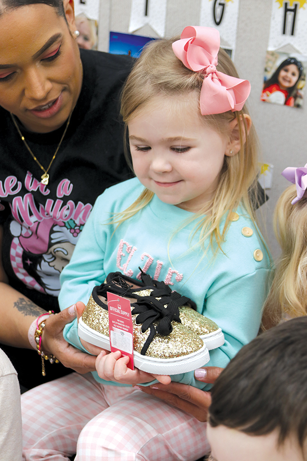 TRISHA MURPHY/Palatka Daily News – Elzie Herrington, 3, holds a pair of donated shoes to be given to a student in need as part of Sneakers for Santa. 