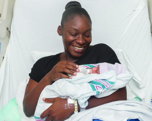 Kymara Boyd and Joziah William Fuller rest in the hospital a day after the child was born.