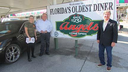 Angel's Diner manager Kayla Davis, left, with longtime customer Tim Smith, center, and Angel's Diner owner John Browning outside Florida's oldest diner.