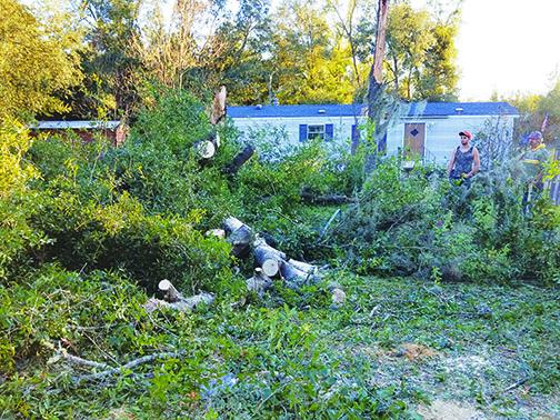 Interlachen residents clean up after a storm ravaged the area.