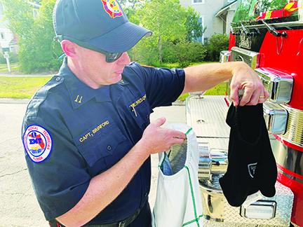 Local firefighters celebrate receiving new equipment Thursday afternoon.