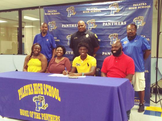 Two-time Daily News Boys Basketball Player of the Year Malik Beauford of Palatka High School is all smiles as he signs his letter of intent Monday to attend classes and play the sport at Lane College in Tennessee. Sitting in the front, from left, are his sister, Makayla, mother Devona, and father Terrance. In the back row, from left, are Palatka High assistants Eugene Blye and Jason Shaw and head coach Bryant Oxendine. (MARK BLUMENTHAL / Palatka Daily News)