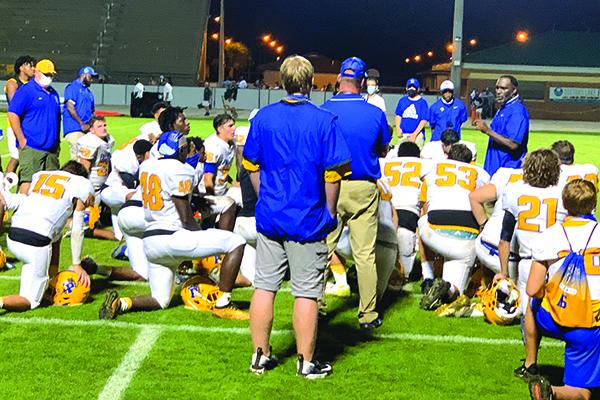 Palatka High School football coach Willie Fells, far right, talks to his players after the Panthers lost to Fleming Island, 29-7, on Friday night. (NICK BLANK / Palatka Daily News)