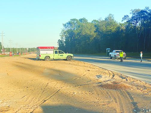 A green truck rests in the median after being involved in a crash on Lady Slipper Lake Road and State Road 20 in Interlachen.