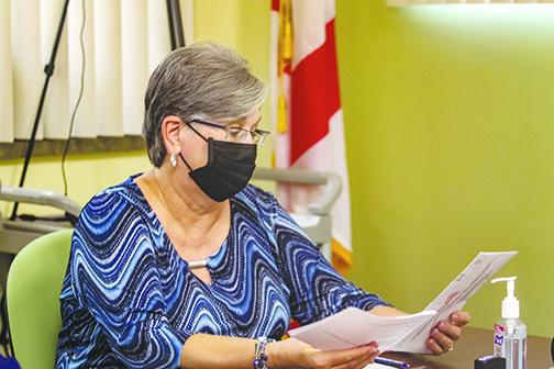 Judge Libby Morris analyzes a mail ballot Friday to check its validity during a Canvassing Board meeting in the Supervisor of Elections Office in Palatka.