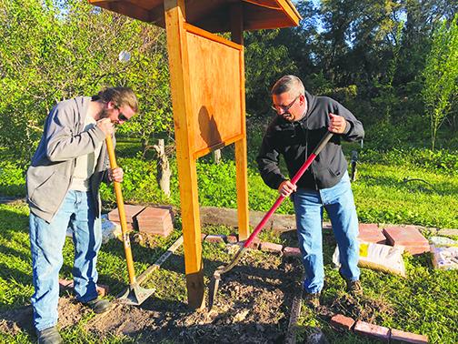 Justin Wilson and Troy Edenfield lay pavers Saturday for a new kiosk at Water Works.