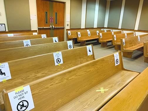 Spaces are marked out on benches in the Putnam County Courthouse Annex. The markings, in addition to mask requirements, are measures put in place because of the COVID pandemic.