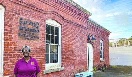 Palatka resident Esther McDuffie stands in front of the old Palatka Water Works building Monday, where she spends some of her time between college classes.