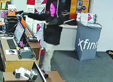 A gun-wielding man is seen in surveillance footage robbing a Boost Mobile store Thursday in Interlachen.