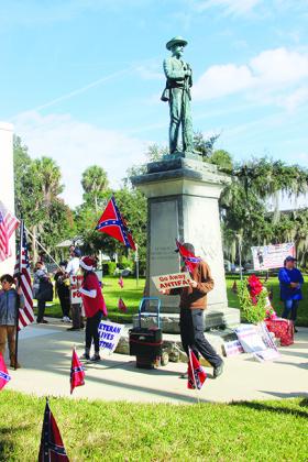Protesters advocate for the Confederate statue remaining on the Putnam County Courthouse lawn during a protest Saturday at the courthouse.