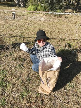 Rhea Smith helps Keep Putnam Beautiful and the Woman’s Club of Palatka spruce up St. Joseph’s Cemetery in Palatka.
