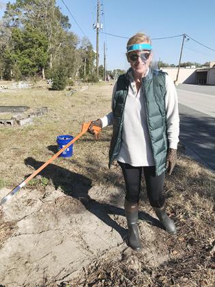 Volunteers Erin Hewes and Woman’s Club of Palatka President Elizabeth Van Rensburg collect trash Monday at St. Joseph’s Cemetery.