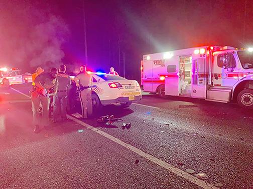 Emergency personnel work the scene of a deputy-involved crash Tuesday night on State Road 20 just west of Palatka. 