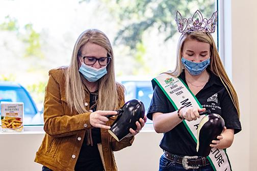 Samantha Harper, the 2020 National Teen Miss Agriculture USA, peels an eggplant with her mom, Abby Houser, on Thursday at Comarco Products in Palatka.