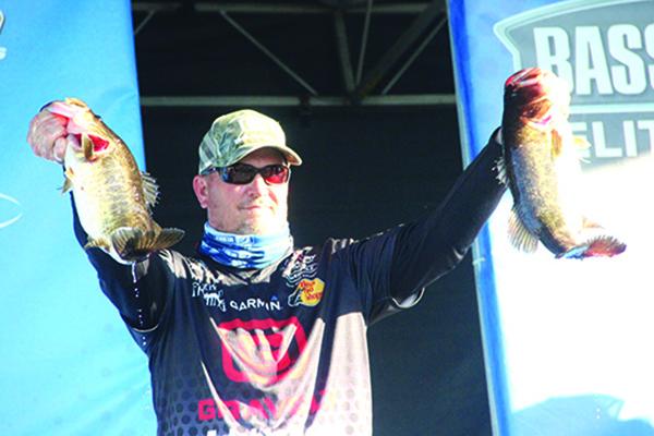 Cliff Prince shows off two of the bass he caught to start the AFTCO Bassmaster Elite At St. Johns River event in fifth place. (ANTHONY RICHARDS / Palatka Daily News)
