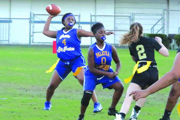 Palatka High School quarterback Chloe Dasher attempts to throw a pass as Zar’Kira Clark (0) blocks for her during the Panthers’ opening game of the season against St. Augustine on Thursday. (ANTHONY RICHARDS / Palatka Daily News)