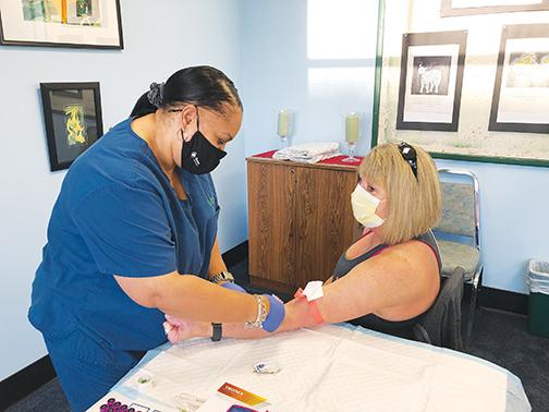 Svea Douglas draws blood from Kim Daley recently as part of Rotary’s annual event, which provides procedures at a lower cost thanks to a partnership with Putnam Community Medical Center.
