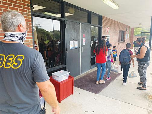 Middleton-Burney Elementary School Principal Rodney Symonds, left, directs foot traffic on the first day of school Aug. 24.