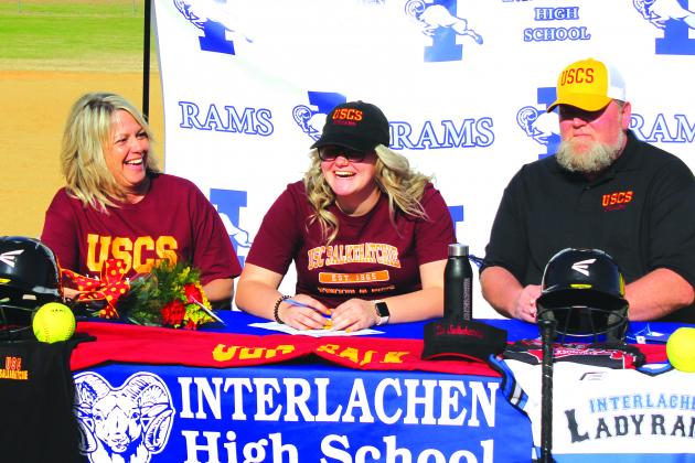Sierra Boynton is all smiles after signing her letter of intent to play softball at South Carolina-Salkehatchie on Jan. 30. Sitting next to her are her mother, Kelly, and father, Larry. (MARK BLUMENTHAL / Palatka Daily News)