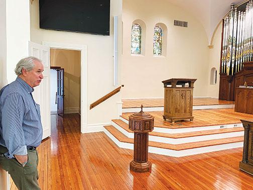 First Presbyterian Church Pastor Cliff Lyda stands inside the revamped sanctuary Wednesday.