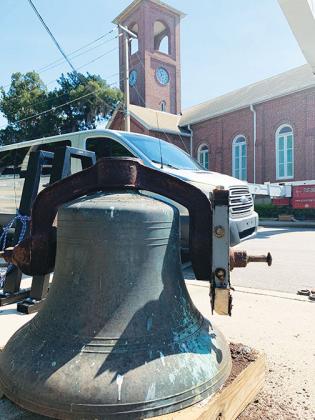 The First Presbyterian Church bell sits on Second Street Wednesday as it is refurbished in a long process that required removing the bell with a crane.