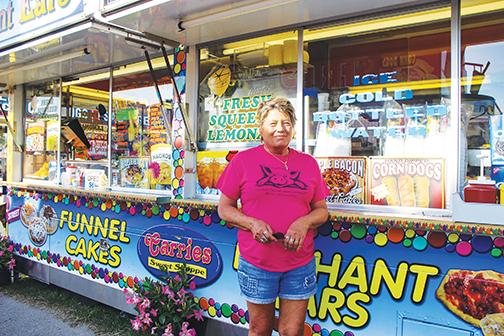 Carrie Howlman stands outside her bakery concession stand, Carrie’s Sweet Shoppe, on Thursday at the Putnam County Fair.