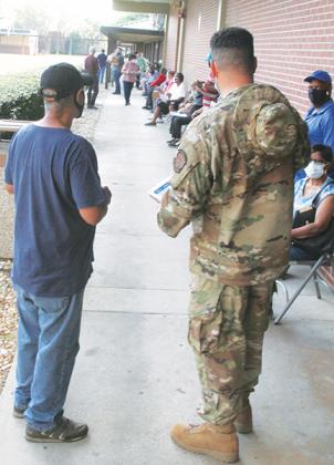 Residents line up early Friday morning to receive the COVID-19 vaccination at St. Johns River State College, which partnered with Mt. Tabor First Baptist Church to provide more than 250 doses. 