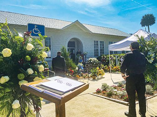 The Rev. Karl Flagg speaks Saturday at Welaka Town Hall during former Mayor Gordon Sands’ funeral.