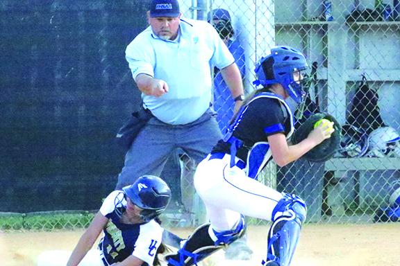 Jacksonville University Christian’s Erin Hutchens is forced out at the plate during the second inning of Tuesday night’s game at Rotary Park against Peniel Baptist Academy. Making the putout is Peniel catcher Summer Langston. (ANTHONY RICHARDS / Palatka Daily News)