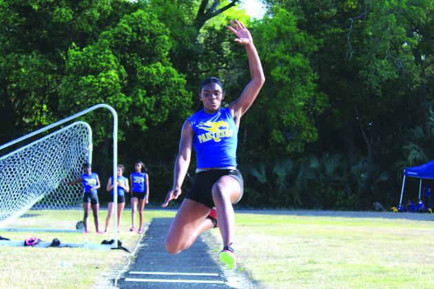 Palatka’s Khi’ya Lookadoo is airborne during the long jump, one of the three events she won on the day. (MARK BLUMENTHAL / Palatka Daily News)