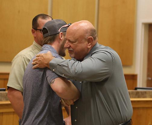 Edward Womble, right, thanks Windstream technician Nicholas Campbell for saving him from a pack of aggressive dogs. Campbell was honored Thursday by the Putnam County Sheriff’s Office with the Life Saving Award. 