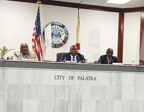Palatka Mayor Terrill Hill, center, talks about the city’s mowing contract with the Florida Department of Corrections during Thursday’s Palatka City Commission meeting.