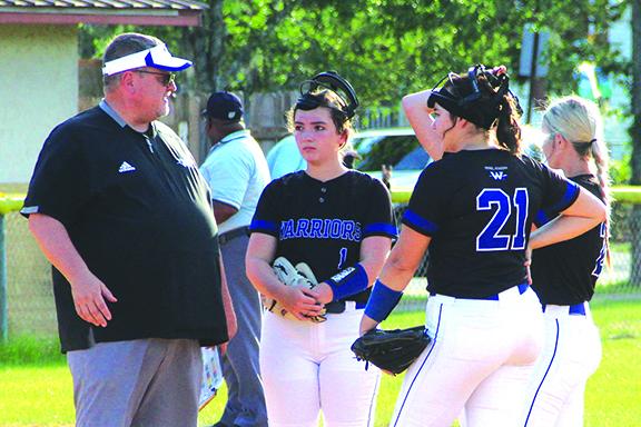 Peniel Baptist Academy softball coach Jeff Hutchins talks to his team during a pitching conference on April 6 against Interlachen. The Warriors host the District 4-2A tournament at Rotary Park next week. (ANTHONY RICHARDS / Palatka Daily News)