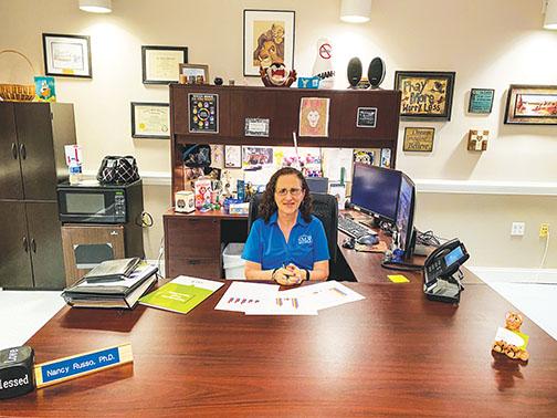 Nancy Russo, vice president of Putnam County Services for SMA Healthcare, sits at her desk after explaining how residents can seek help for substance use and mental health issues.